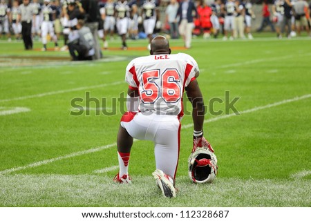 WARSAW, POLAND - SEPTEMBER 1: American football player, US team member Mike Gee (DL/LB) kneels down on the field before the game during Euro-American Challenge match on September 1, 2012 in Warsaw.