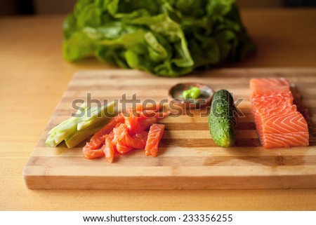 Raw salmon, wasabi sauce, majo, soya sauce, prawn and avocado, cucumber prepared for sushi. You can find it at japanese restaurant. Japan, japanese food, Asia. Nobody.