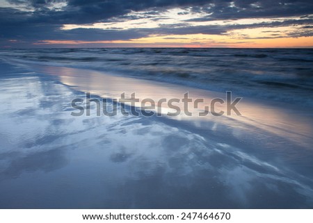 Mediterranean Sea coast during sunset. Sand seaside and sea. Holidays in Spain. Landscape view. Nature, wildlife. Summer.