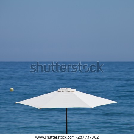 white parasol blue sea holidays