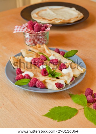 Traditional crepes with creame fresh raspberry and mint