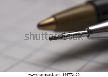 macro detail notebook with mechanical pencil and pen isolated on white