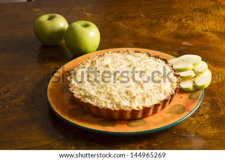 Apple cake with two slices of apple on an old wooden table.