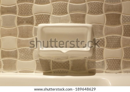 Image soap tray on wall in the bath room under tungsten light