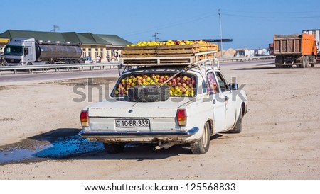 ZARAT - AZERBAIJAN SEPTEMBER 13: Old type car fully loaded with apples by the highway, on September 13, 2012. Individual economic activity is still very important in rapidly developing Azerbaijan.