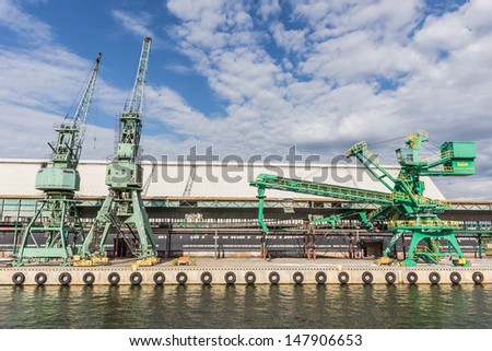 GDANSK, POLAND - JULY 11: Cranes on the quay on July 11, 2013 in the Port of Gdansk, the largest seaport in Poland, a major transportation hub in the central part of the southern Baltic Sea coast.