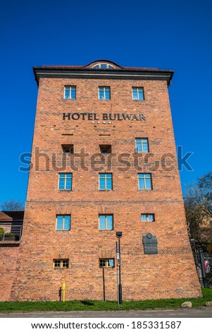 TORUN, POLAND - MARCH 30, 2014: Hotel Bulwar on Vistula river bank. Since 1822 when built served as Prussian barracks, Poland Navy's Officer School and college dormitory, converted into hotel in 2001.