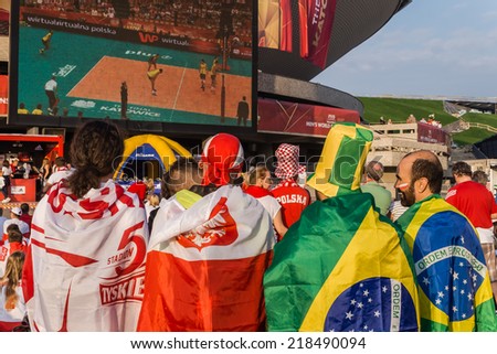 KATOWICE, POLAND - SEPTEMBER 20, 2014: Polish and Brazilian fans watch Brazil vs France match on the screen in the fanzone at Spodek Arena during FIVB Volleyball Men\'s World Championship Poland 2014.