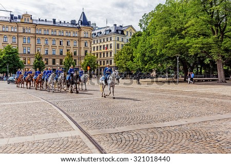 STOCKHOLM - AUGUST 11, 2015: Squadron returns to barracks after changing of the guard at the Royal Palace. The Royal Guard was established in 1523 and continuously guards the Royal Palace since then.