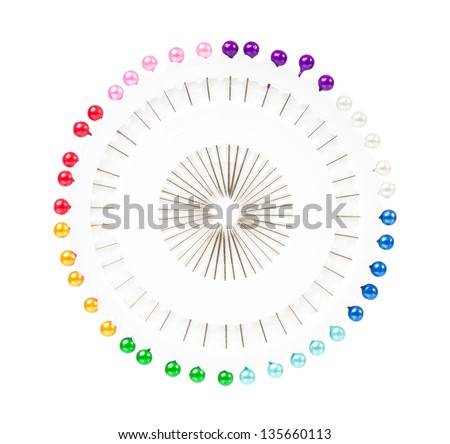 Colorful pins in a needle bed isolated on white background cutout