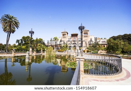Mudejar Pavilion and pond at sunset. Placed in the Plaza de America, houses the Museum of Arts and Traditions of Sevilla, Spain. Built in 1928 for the Ibero-American Exposition of 1929