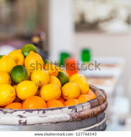 Barrel of Fresh Lemons, Limes and Oranges on Street Market