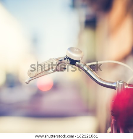 Detail of a Vintage Bike Handlebar with a Colorful Background Bokeh
