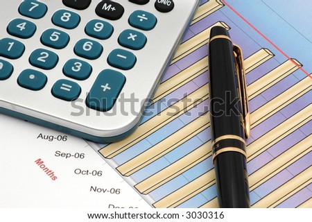 Close-up of Stock Market Volume Bar Chart, Calculator and Pen