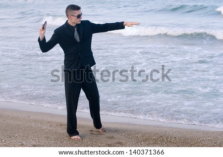 Businessman throwing his phone in the water