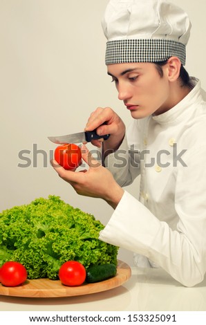 Beautiful chef preparing a green salad for a perfect healthy life