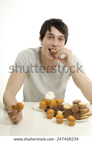 Man in love with sweets, candies,chocolate and sugar but trying to withhold. Forbidden sweets for a healthy longer life