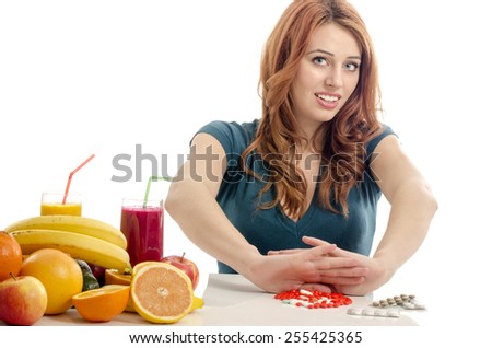 Patient saying no to medical treatment. Beautiful woman refuses to take pills and choose to eat organic raw fruits, salad, smoothie, juices for a healthy life