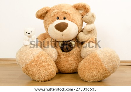 A family of teddy bears, big bear protecting the smaller ones, bear toys