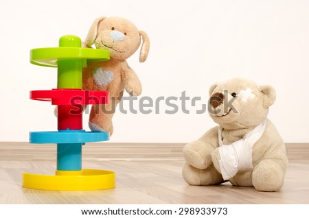 Teddy bear having fun. Two bear toy playing, one with a broken hand wrapped in bandages.