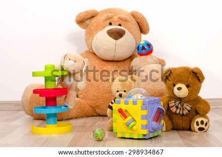 Teddy bear having fun. Many bear toys playing, one big bear watching his little bears playing with balls and boxes