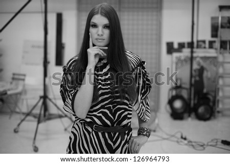 beautiful girl in zebra pattern dress, in the studio thinking, black and white