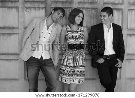 Portrait of a group of business people working together , young group of business people, Portrait of group of people,girl and two boys, friends, based on the wall black and white