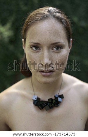young woman with an interesting necklace made of black cubes