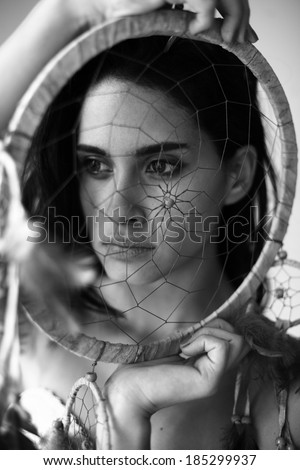 image of a woman with a dream catcher , girl in traditional Indian wear and dream catcher posing to the camera ,