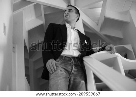 business man on white stairs looking away black and white