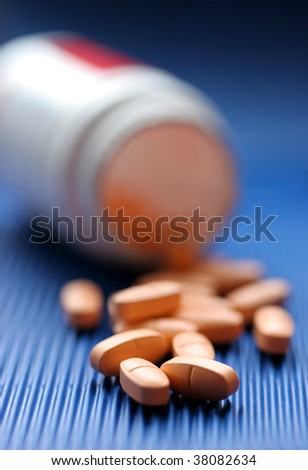 Group pills are poured out of the box on a blue background