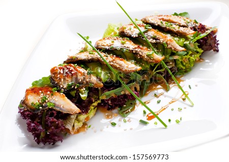 Light meal from eel. Salad with avacado, eel, lettuce and Unagi Sauce.