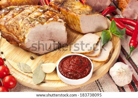 Different types of home-made pork arranged with sauce and vegetables.