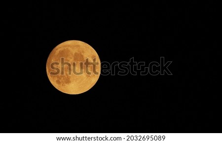 Full Orange Moon movement across the sky on July 23, 2021. Halloween Moon concept.