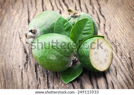 Feijoa fruits on old wooden table.