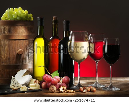 Still-life with wine, cheeses and fruits.