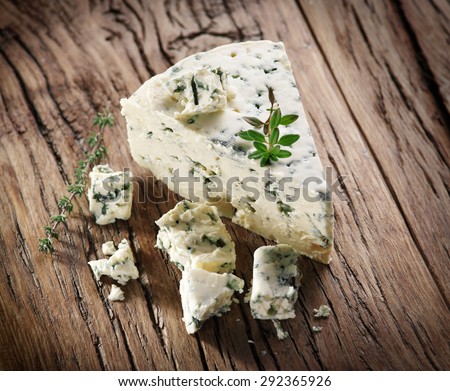 Slices of Danish Blue cheese on an old wooden table.