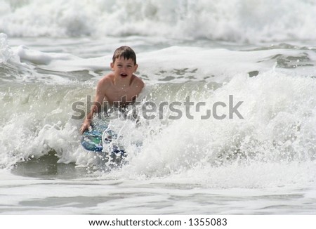 boy on surf board at Sunset Beach North Carolina
