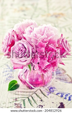 Floral composition with a pink peony ,hydrangea and roses in a glass vase. Pink flowers.