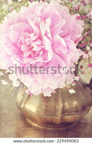 floral composition with a peony flower in vintage jug .
