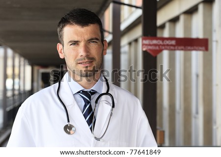 young doctor with stethoscope in hospital hall