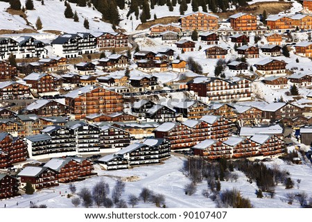 alpine village with chalets in winter, France