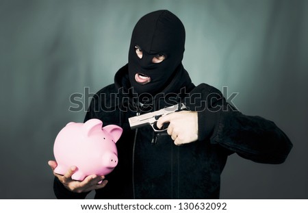 man with a gun and piggy bank, special photographic processing