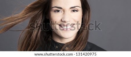 Panoramic portrait of beautiful woman model with hair in the wind