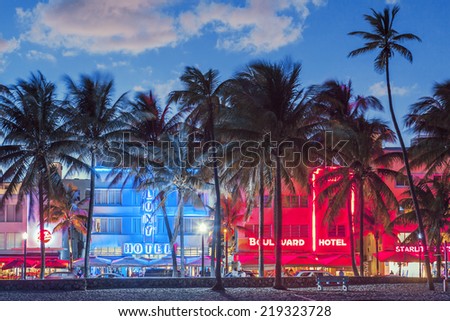 MIAMI, FLORIDA - JANUARY 24, 2014: Palm trees line Ocean Drive. The road is the main thoroughfare through South Beach.