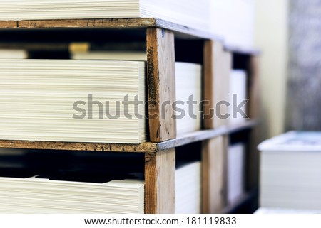 blank sheets of paper on the wooden shelf in the  printing house