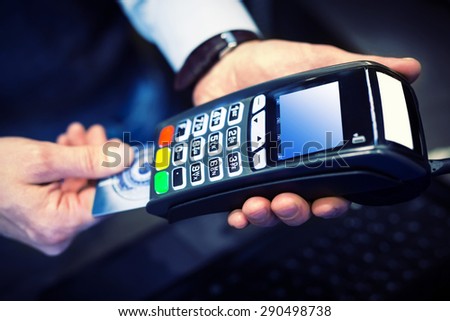 Payment with credit card - man put the credit card into a reader