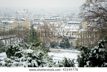 Rare snowy day in Paris. Parisian roofs covered with snow, view from the Montmartre hill