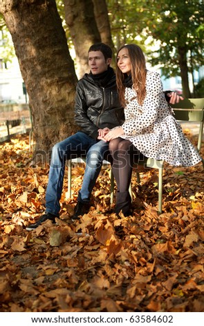 Young couple in the Luxembourg garden of Paris at fall