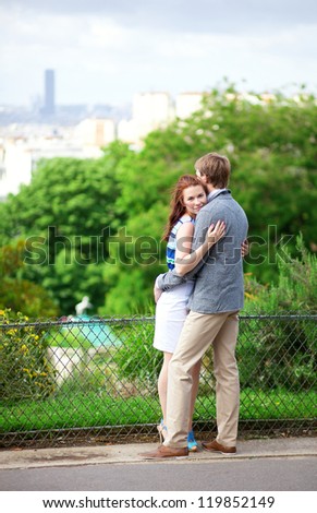 Sensual romantic couple is hugging in park on Montmartre in Paris